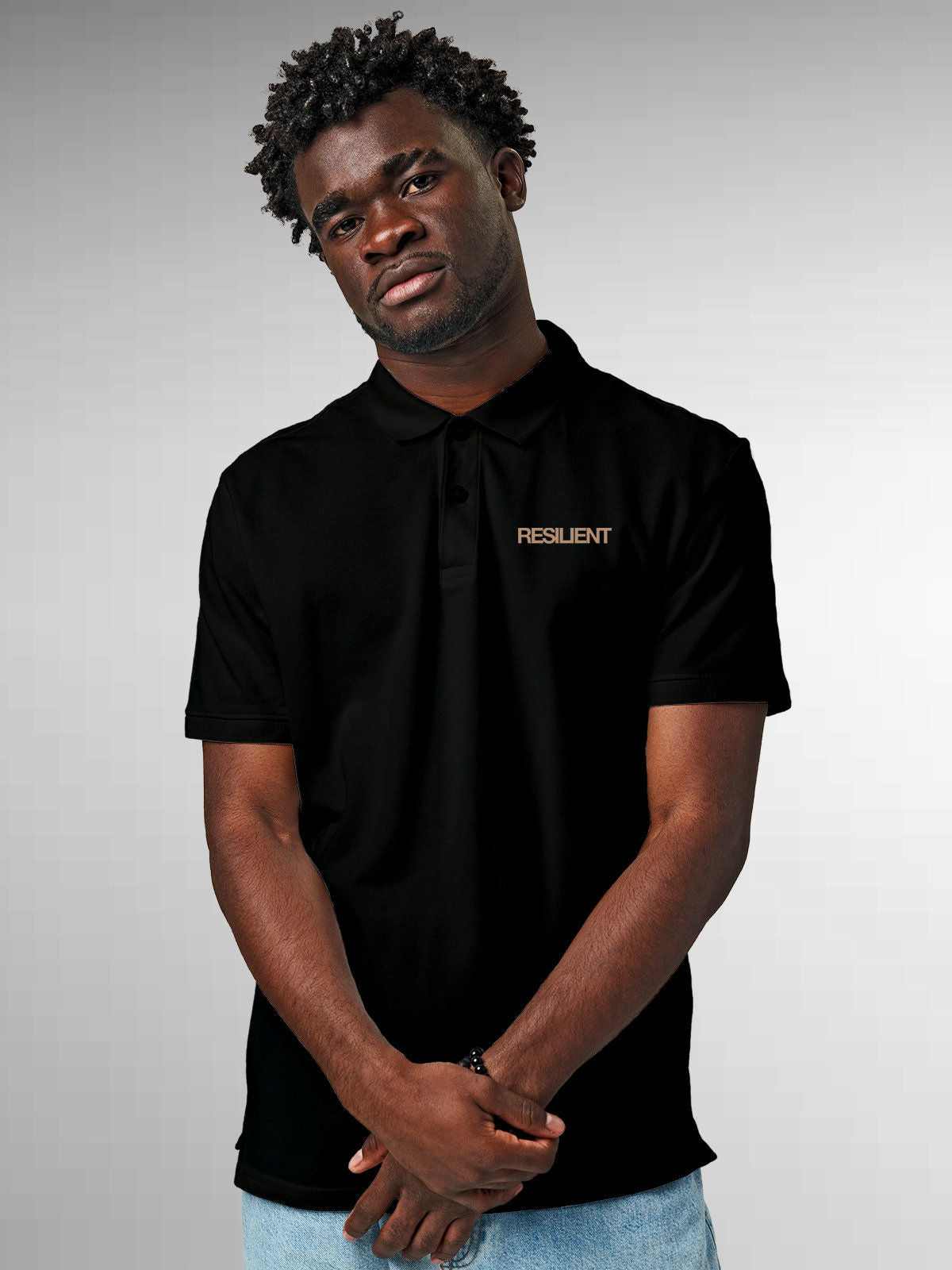Model wearing Men's Black Polo T-shirt with 'Resilient' design, offering effortless style and premium comfort