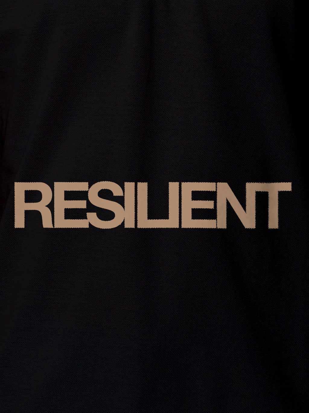 Close up of 'Resilient' design on Women's Black Polo T-shirt, highlighting intricate details and vibrant print.