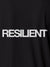 Close up of 'Resilient' design on Men's Dark Grey Polo T-shirt, highlighting intricate details and vibrant print.