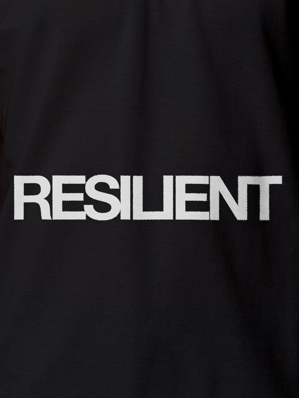 Close up of 'Resilient' design on Women's Dark Grey Polo T-shirt, highlighting intricate details and vibrant print.