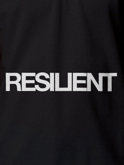 Close up of 'Resilient' design on Women's Dark Grey Polo T-shirt, highlighting intricate details and vibrant print.