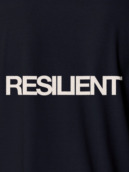 Close up of 'Resilient' design on Men's Navy Blue Polo T-shirt, highlighting intricate details and vibrant print.