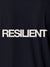 Close up of 'Resilient' design on Men's Navy Blue Polo T-shirt, highlighting intricate details and vibrant print.