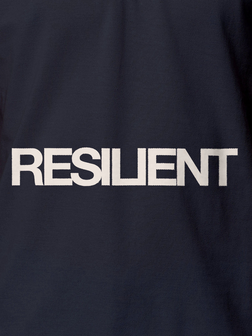 Close up of 'Resilient' design on Women's Navy Blue Polo T-shirt, highlighting intricate details and vibrant print.
