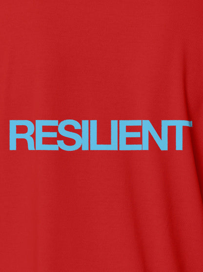 Close up of 'Resilient' design on Men's Red Polo T-shirt, highlighting intricate details and vibrant print.