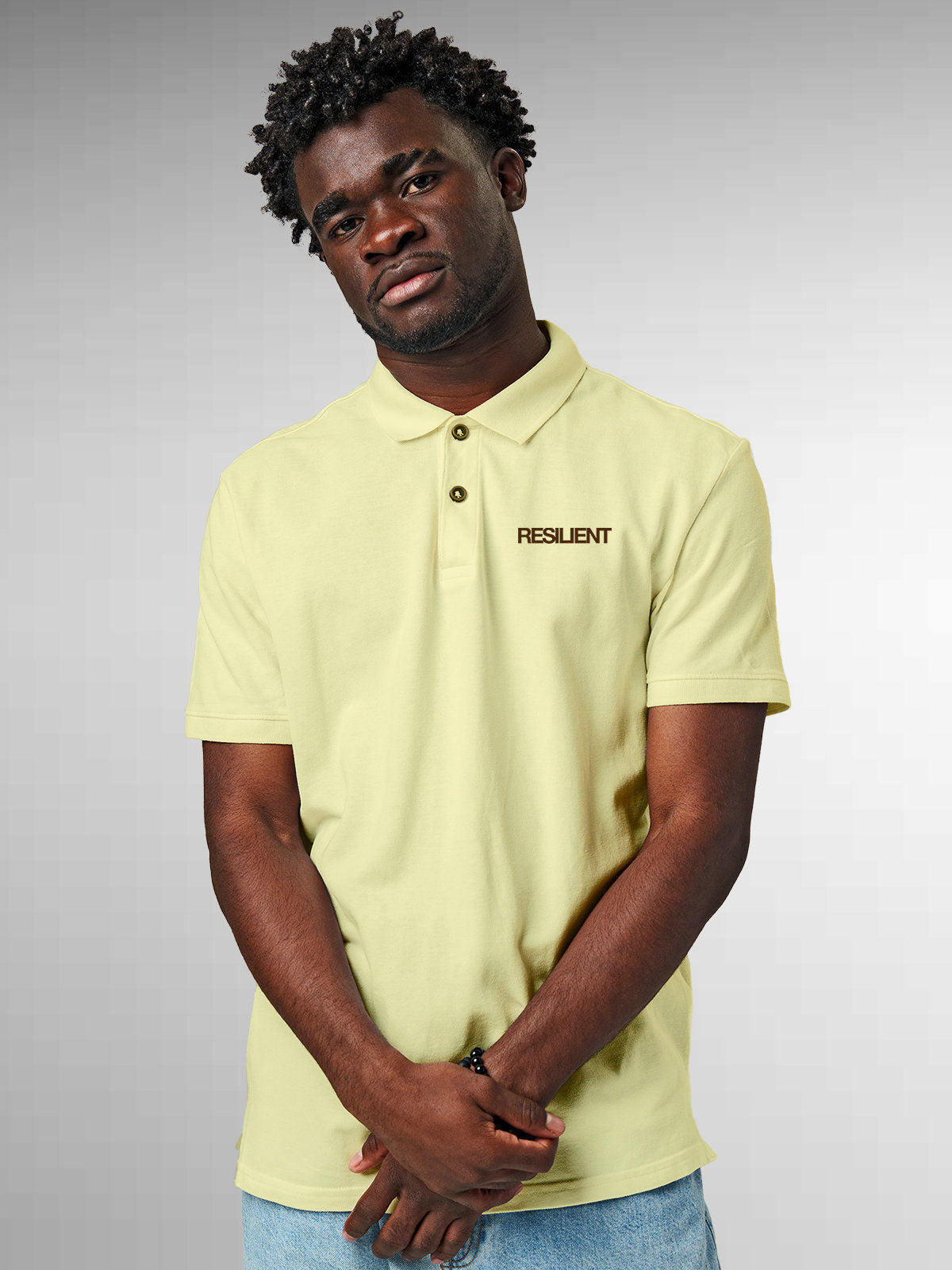 Model wearing Men's Yellow Polo T-shirt with 'Resilient' design, offering effortless style and premium comfort