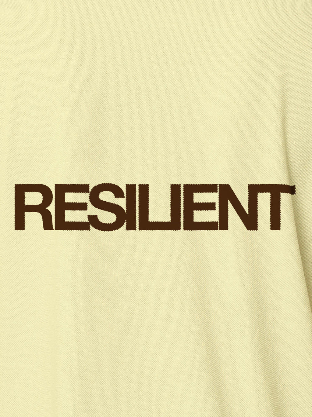 Close up of 'Resilient' design on Men's Yellow Polo T-shirt, highlighting intricate details and vibrant print.