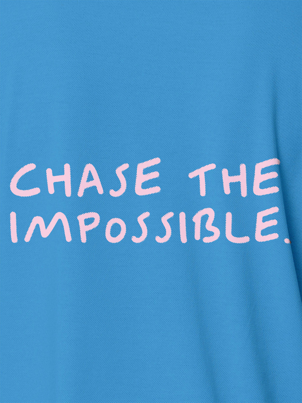 Close up of 'Chase The Impossible' design on Men's Blue Polo T-shirt, highlighting intricate details and vibrant print.