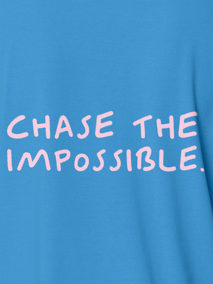 Close up of 'Chase The Impossible' design on Men's Blue Polo T-shirt, highlighting intricate details and vibrant print.