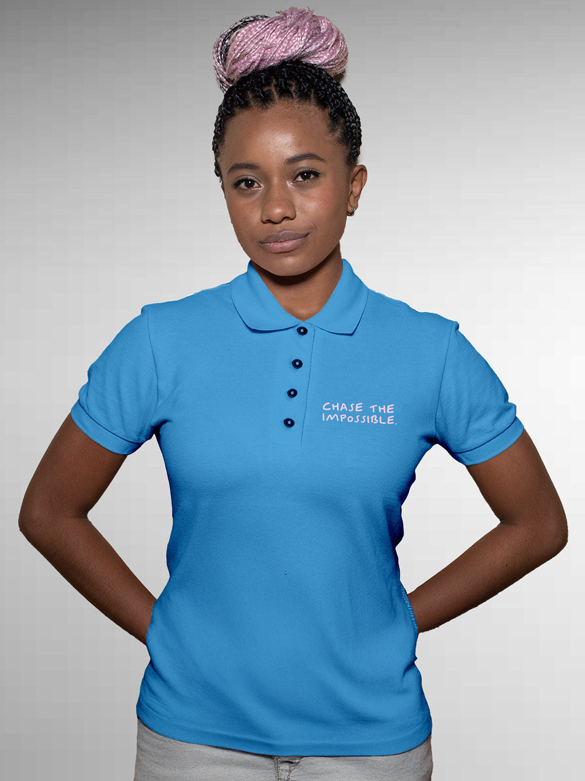 Model wearing Women's Blue Polo T-shirt with 'Chase The Impossible' design, offering effortless style and premium comfort