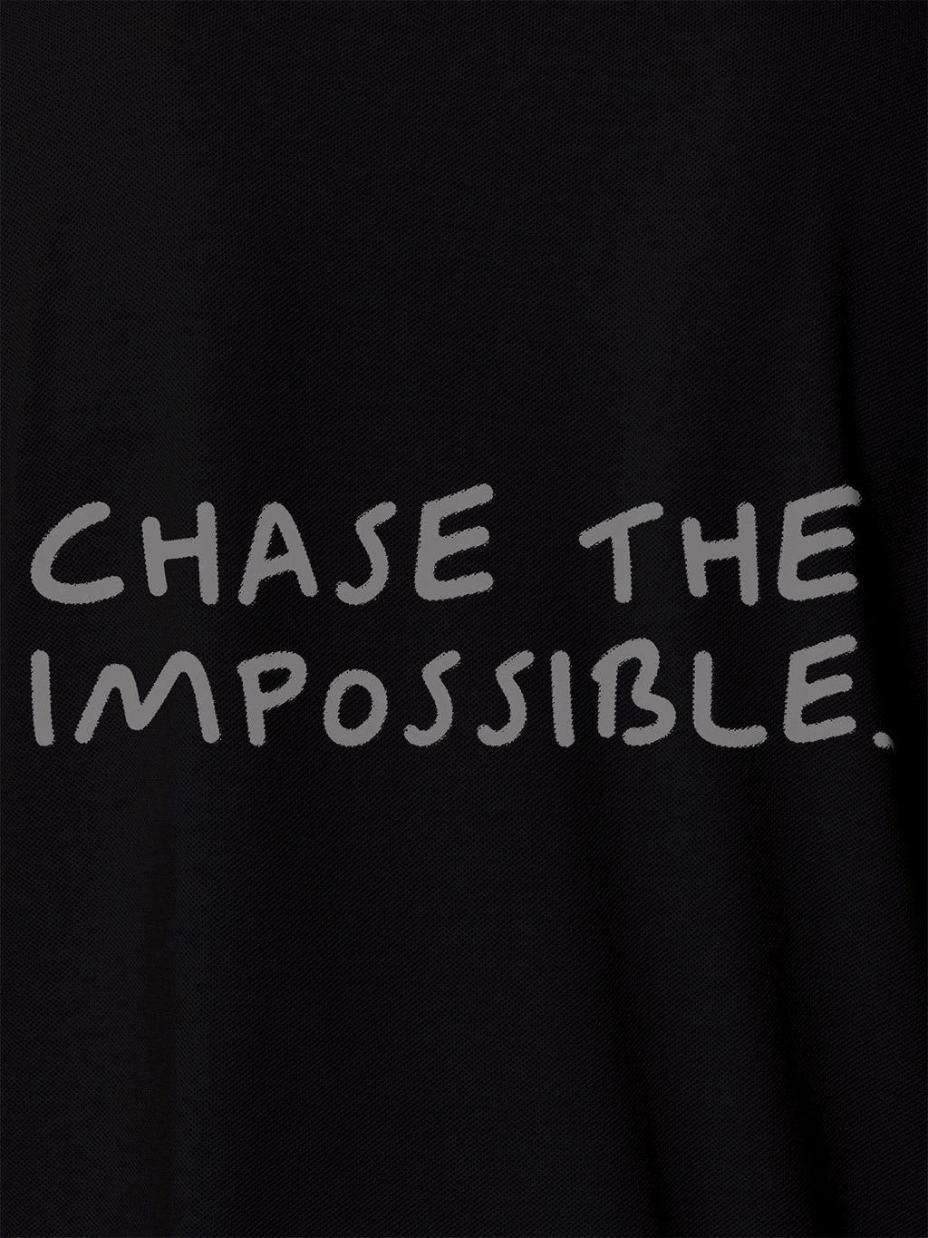 Close up of 'Chase The Impossible' design on Men's Black Polo T-shirt, highlighting intricate details and vibrant print.