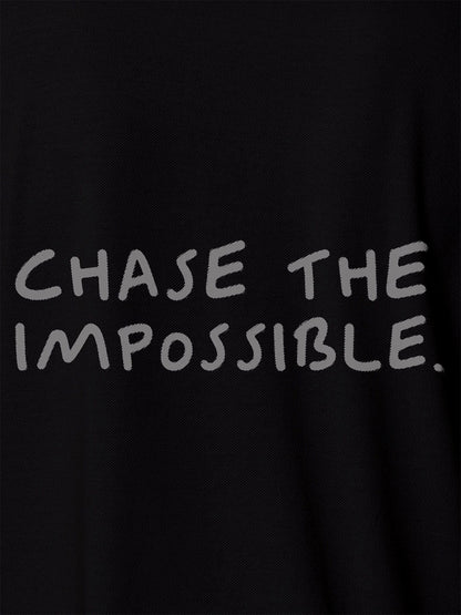 Close up of 'Chase The Impossible' design on Men's Black Polo T-shirt, highlighting intricate details and vibrant print.