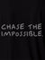 Close up of 'Chase The Impossible' design on Men's Black Polo T-shirt, highlighting intricate details and vibrant print.