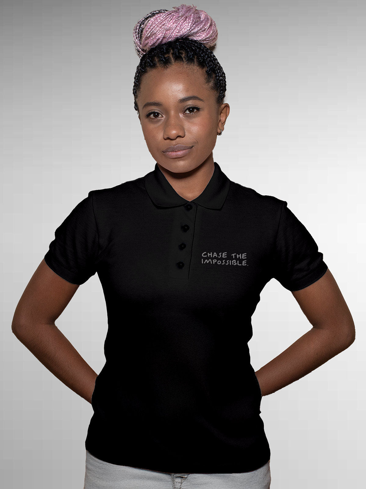 Model wearing Women's Black Polo T-shirt with 'Chase The Impossible' design, offering effortless style and premium comfort
