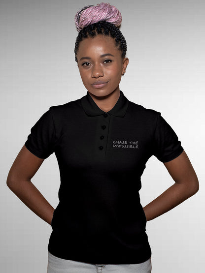 Model wearing Women's Black Polo T-shirt with 'Chase The Impossible' design, offering effortless style and premium comfort