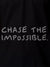 Close up of 'Chase The Impossible' design on Women's Black Polo T-shirt, highlighting intricate details and vibrant print.