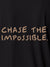 Close up of 'Chase The Impossible' design on Men's Dark Grey Polo T-shirt, highlighting intricate details and vibrant print.
