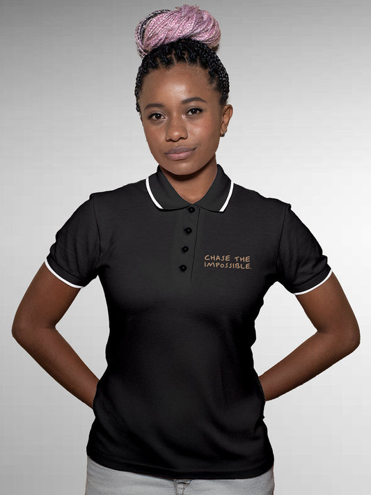 Model wearing Women's Dark Grey Polo T-shirt with 'Chase The Impossible' design, offering effortless style and premium comfort