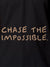 Close up of 'Chase The Impossible' design on Women's Dark Grey Polo T-shirt, highlighting intricate details and vibrant print.