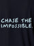 Close up of 'Chase The Impossible' design on Men's Navy Blue Polo T-shirt, highlighting intricate details and vibrant print.