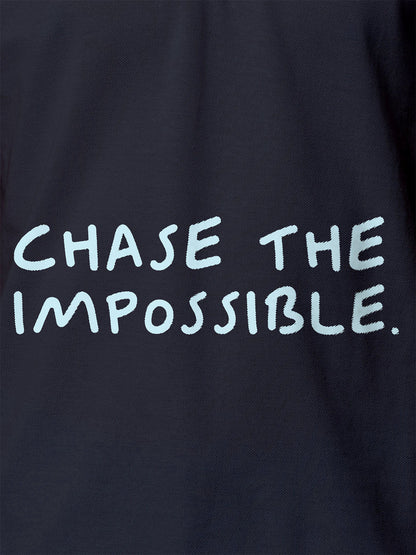 Close up of 'Chase The Impossible' design on Women's Navy Blue Polo T-shirt, highlighting intricate details and vibrant print.