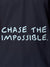 Close up of 'Chase The Impossible' design on Women's Navy Blue Polo T-shirt, highlighting intricate details and vibrant print.