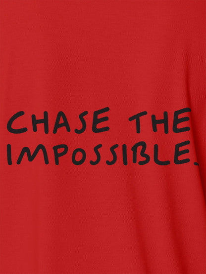 Close up of 'Chase The Impossible' design on Men's Red Polo T-shirt, highlighting intricate details and vibrant print.