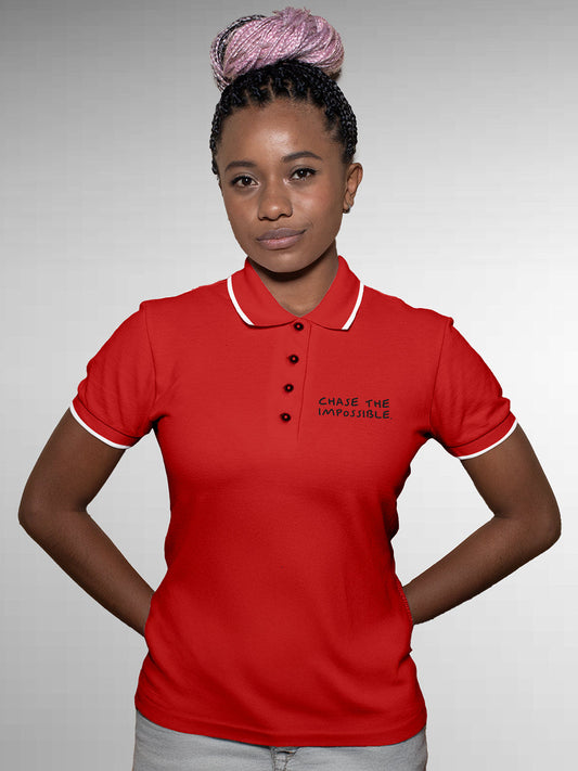 Model wearing Women's Red Polo T-shirt with 'Chase The Impossible' design, offering effortless style and premium comfort