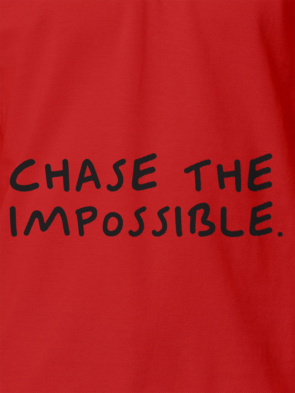 Close up of 'Chase The Impossible' design on Women's Red Polo T-shirt, highlighting intricate details and vibrant print.