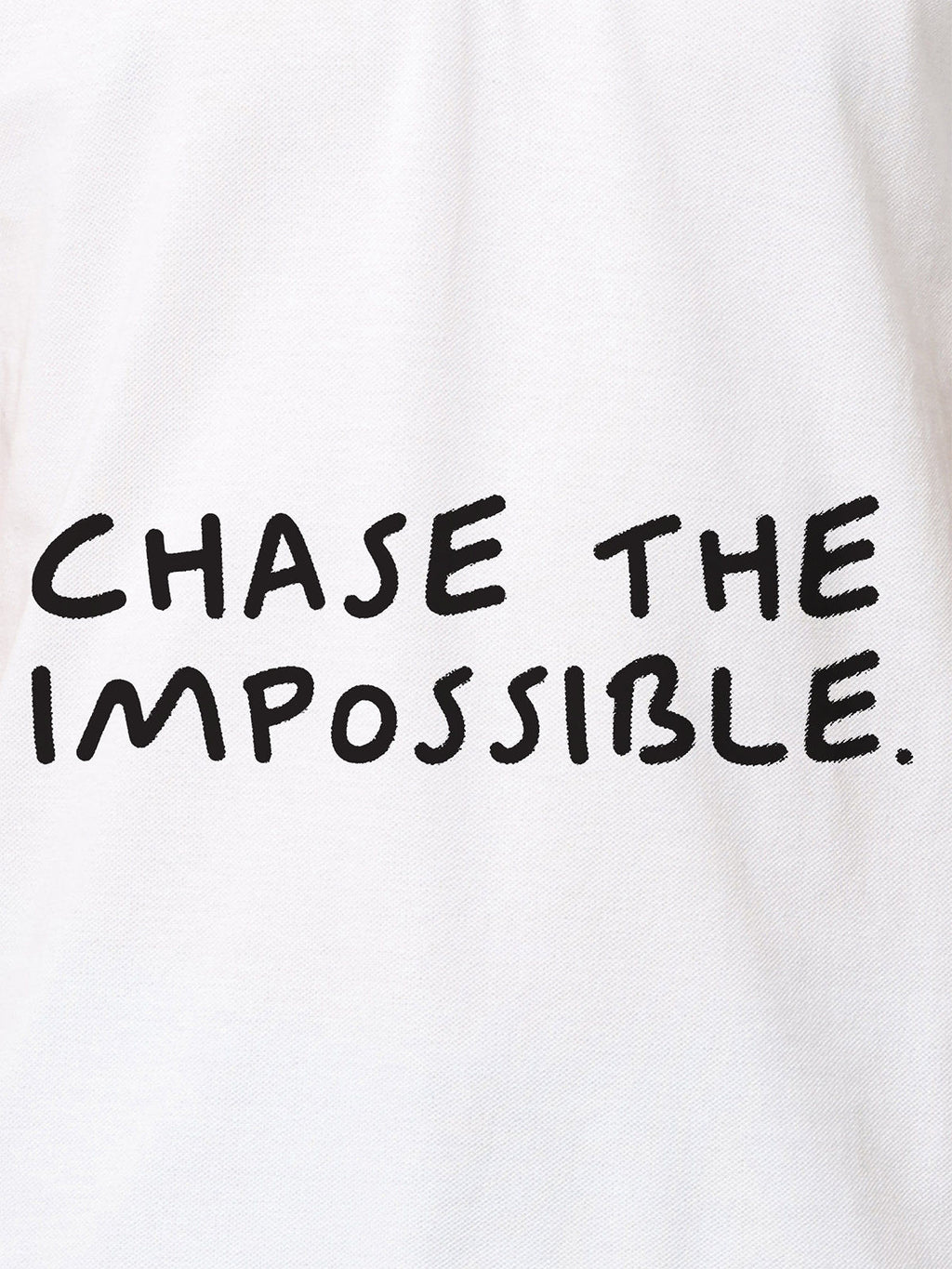 Close up of 'Chase The Impossible' design on Women's White Polo T-shirt, highlighting intricate details and vibrant print.
