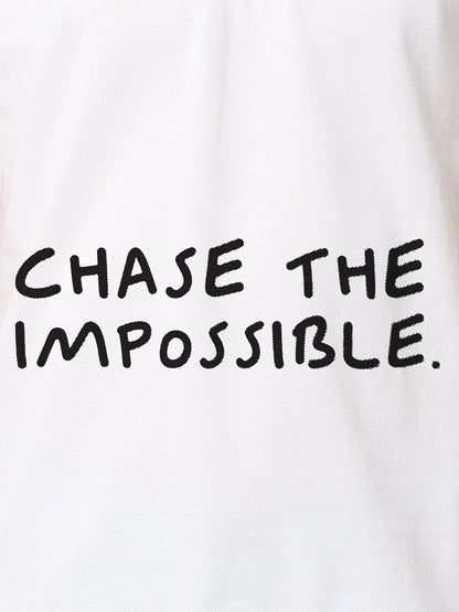 Close up of 'Chase The Impossible' design on Women's White Polo T-shirt, highlighting intricate details and vibrant print.