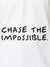 Close up of 'Chase The Impossible' design on Women's White Polo T-shirt, highlighting intricate details and vibrant print.