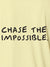 Close up of 'Chase The Impossible' design on Men's Yellow Polo T-shirt, highlighting intricate details and vibrant print.
