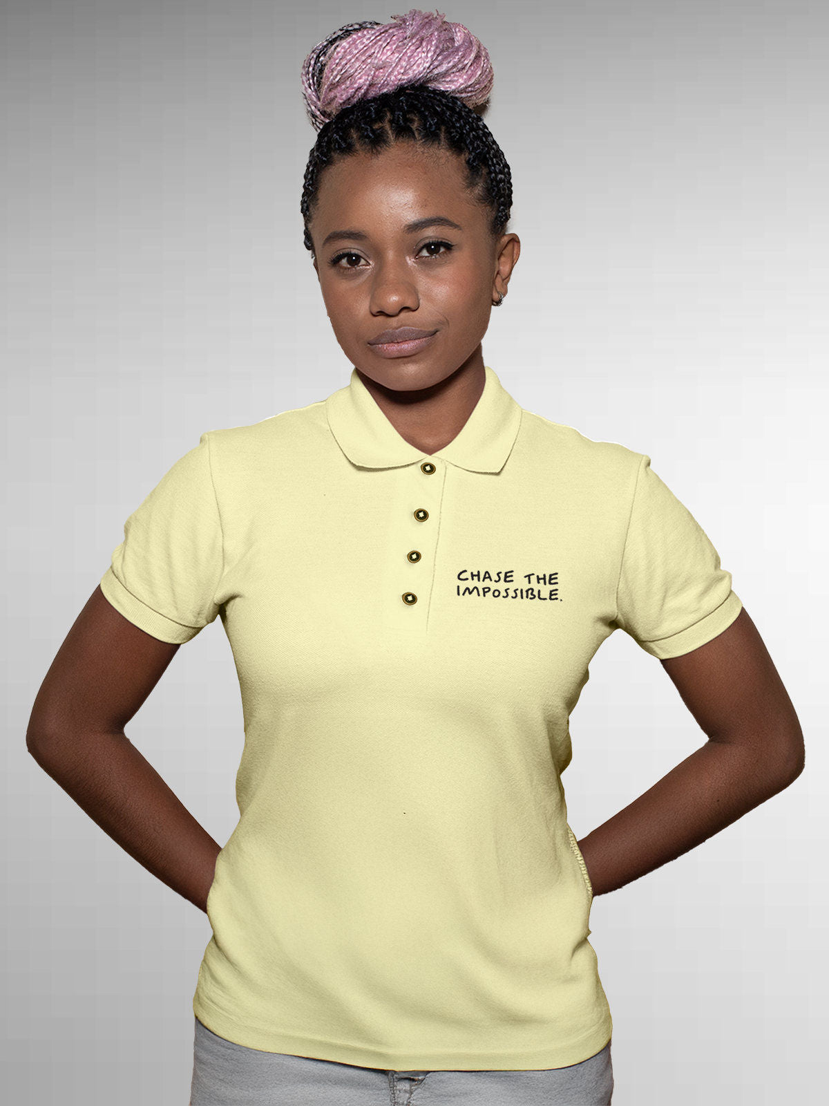 Model wearing Women's Yellow Polo T-shirt with 'Chase The Impossible' design, offering effortless style and premium comfort