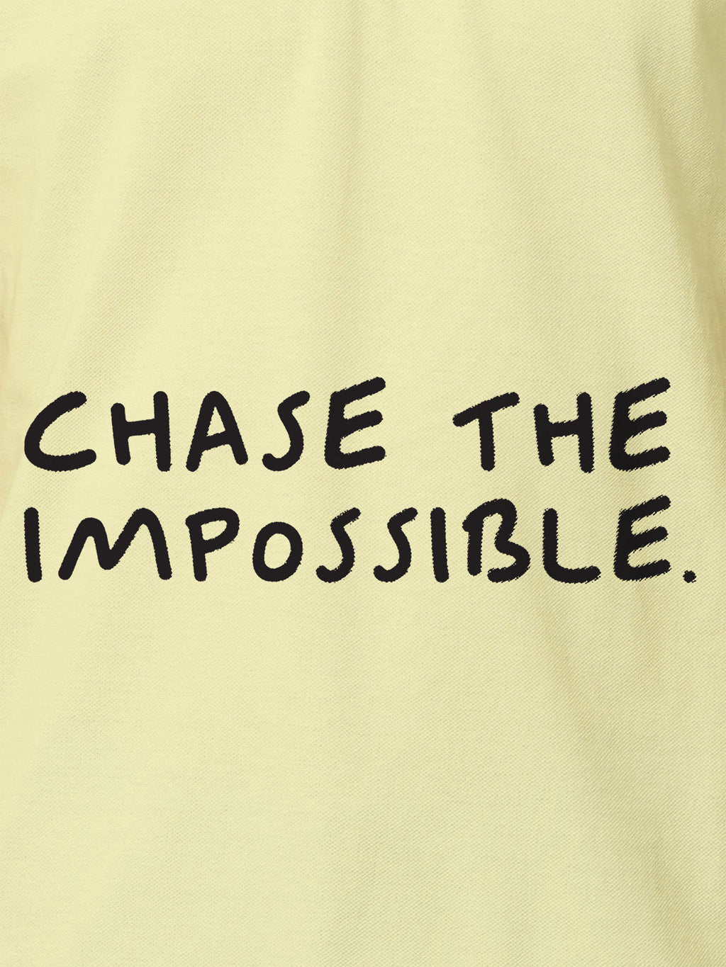 Close up of 'Chase The Impossible' design on Women's Yellow Polo T-shirt, highlighting intricate details and vibrant print.