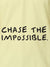Close up of 'Chase The Impossible' design on Women's Yellow Polo T-shirt, highlighting intricate details and vibrant print.